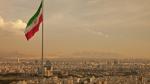 Iran flag waving in the wind above skyline of Tehran lit by orange glow of sunset. Iran flag waving in the wind above the skyline of Tehran lit by the orange glow of sunset.
