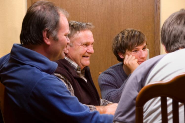 Family talking and smiling around the table